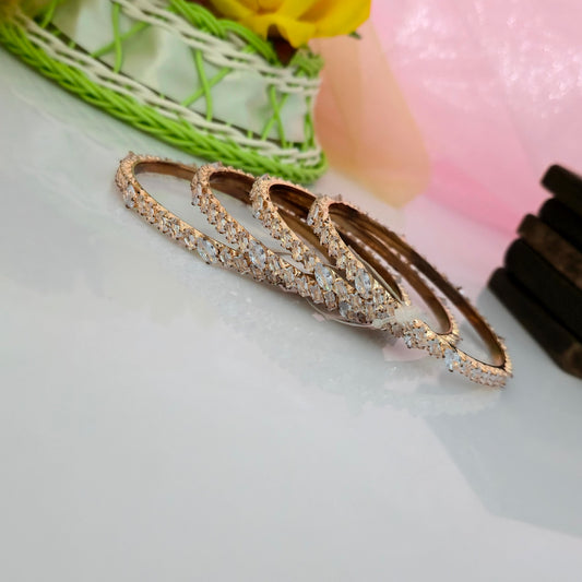 AD oval cut four row bangles, american diamond bangles for women, sparkling oval stone bangles, gold finish designer bangles, CZ bangles for women, bridal party wear bangles, artificial diamond jewellery