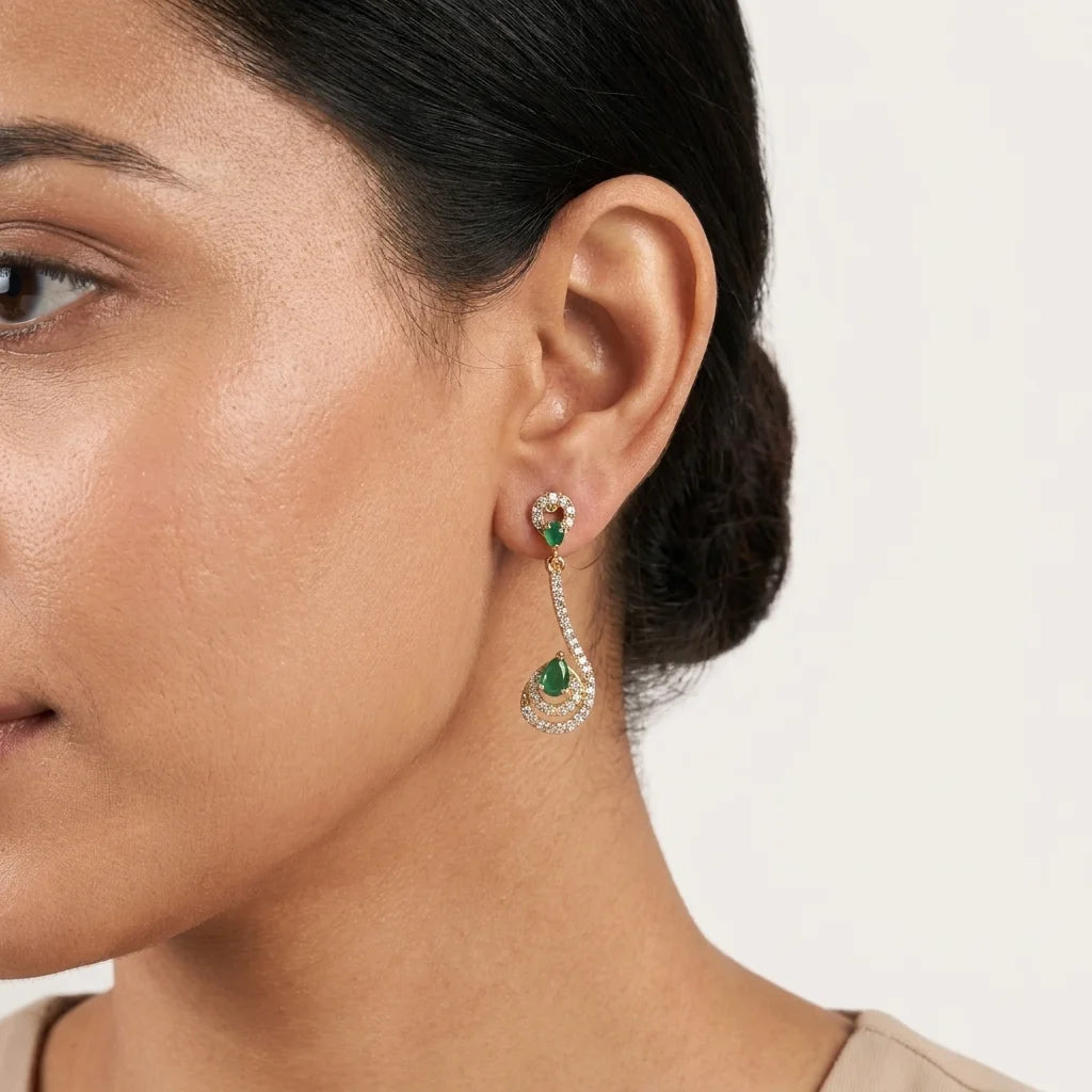 AD zirconia green stone earrings, designer drop earrings, gold ethnic earrings, emerald zirconia earrings, festive womens earrings, long party wear earrings, water resistant earrings