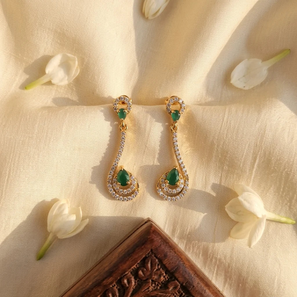 AD zirconia green stone earrings, designer drop earrings, gold ethnic earrings, emerald zirconia earrings, festive womens earrings, long party wear earrings, water resistant earrings
