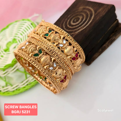 adjustable gold plated screw bangles for women, traditional peacock design bangles with green red and white stones, antique gold tone broad bangles, designer screw bangles with intricate ornamental detailing, traditional Indian wedding bangles, gold plated ethnic jewellery for women, colourful stone embellished bangles, Scofjewel gold plated bangles