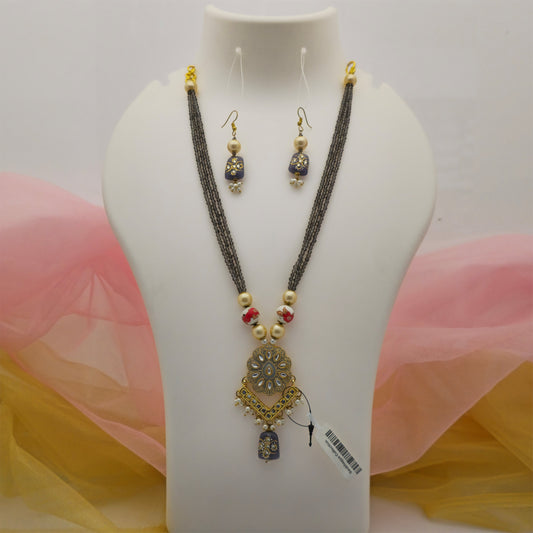 black beads pendant long necklace mala for women, black faceted bead necklace with gold-tone pendant, traditional black necklace mala with matching earrings, black and gold artificial jewellery necklace set, long necklace with red floral beads and pearl-style drops, designer ethnic necklace mala for festive wear