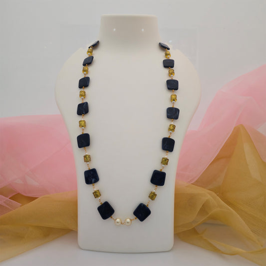 black square beads long necklace mala, black and gold designer necklace mala for women, square black bead necklace with gold-tone decorative beads, long artificial jewellery necklace for women, modern black necklace mala with cream pearl accents, contemporary imitation jewellery for ethnic and western wear
Google Title