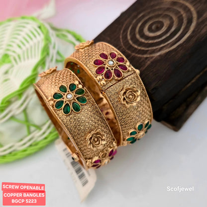 copper screw openable bangles with red and green floral stones, antique gold tone designer copper bangles, traditional copper bangles with honeycomb texture, floral stone embellished ethnic bangles, screw openable bangles for women, red green and clear stone copper bangles, traditional Indian festive jewellery, Scofjewel copper bangles BGCP 5223
