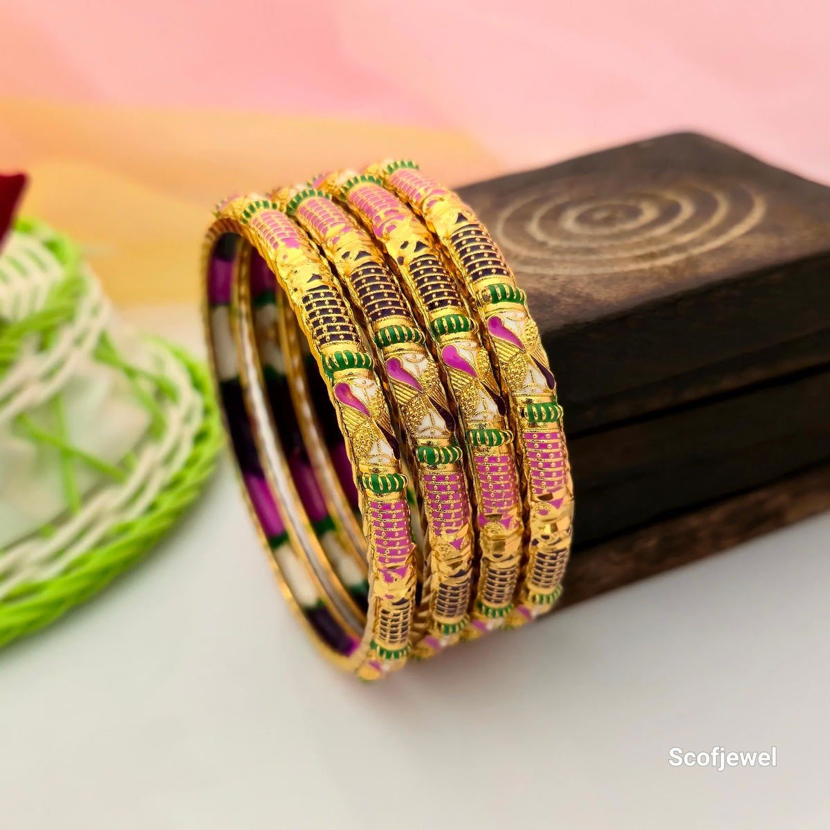 gold tone multicolour designer bangles set of four, pink and green traditional bangles for women, gold bangles with purple and white decorative accents, colourful ethnic bangles with intricate patterns, traditional Indian imitation jewellery bangles, festive wear bangles for women, designer bangles for weddings and celebrations, Scofjewel multicolour bangles