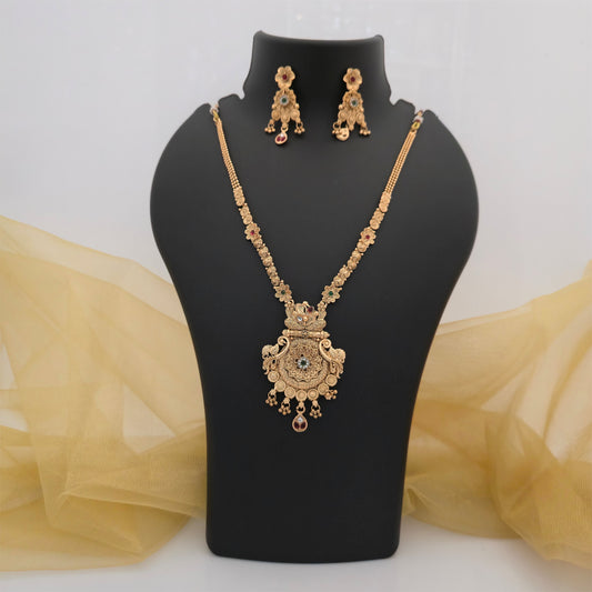 gold plated Rajwadi polish necklace set with ornate antique style floral pendant, intricate gold tone filigree detailing, red green and white stone accents, decorative hanging embellishments, matching drop earrings, traditional artificial jewellery for women, wedding and festive necklace set
