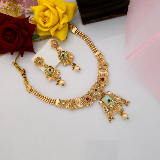 Gold plated Rajwadi polish short necklace set with green enamel pendant, red stone embellishments, antique gold motifs, pearl drop details and matching traditional earrings for women