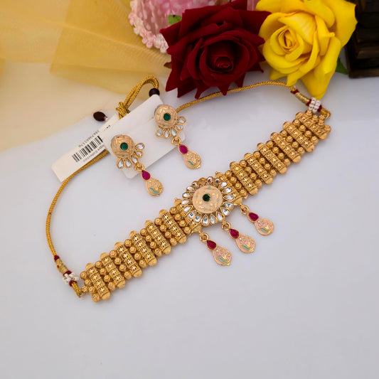 Gold plated Rajwadi polish short necklace set with peach enamel floral centrepiece, green stone accents, pink teardrop drops, white decorative stones and matching traditional earrings for women