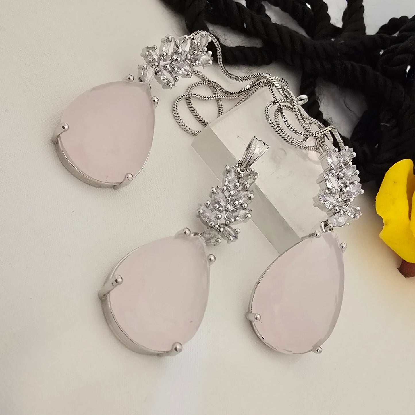 Jewelry_set_with_teardrop-shaped_pendants_and_chains_on_a_white_surface. - Saubhagya Collection 