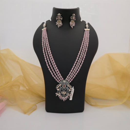light pink beaded Moissanite Kundan long necklace set with matching earrings, multi strand pink oval bead necklace for women, pink statement pendant with white decorative stones, antique silver tone traditional necklace with gold tone accents, pink Kundan-style ethnic jewellery set, designer pink necklace for weddings and festive occasions, elegant long beaded necklace with matching earrings, Scofjewel pink necklace set