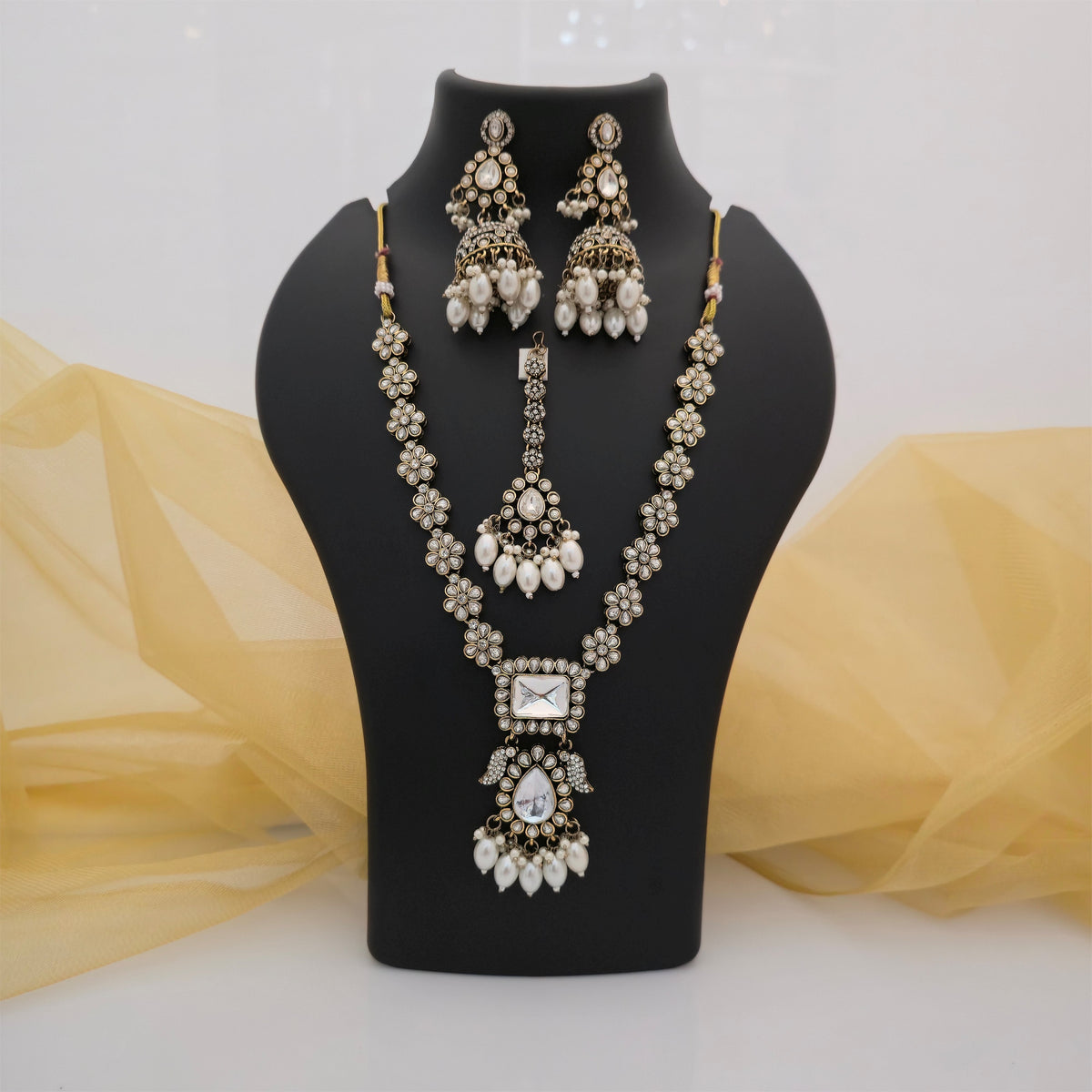 moissanite and AD necklace set with pearl drops, moissanite floral necklace with matching jhumka earrings, American diamond necklace set with maang tikka, gold tone designer necklace with white stone detailing, pearl drop wedding jewellery set for women, traditional moissanite and AD jewellery set, elegant floral necklace for bridal and festive wear, Scofjewel moissanite necklace set