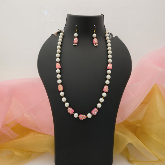 pink and cream pearl beads long necklace mala set, pink decorative bead necklace with cream pearl-style beads, gold tone long necklace with matching earrings, traditional artificial jewellery set for women, pink and cream imitation necklace for festive wear, elegant designer necklace mala for ethnic outfits