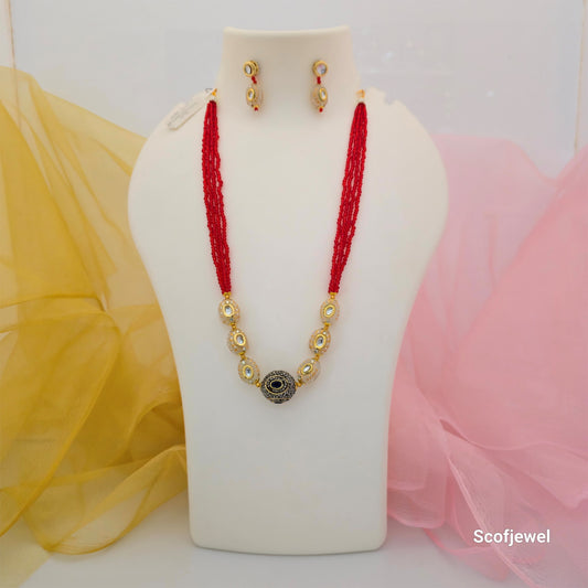 red beads gold tone necklace set with matching earrings, multi strand red bead necklace for women, red and gold artificial jewellery set, necklace with black centre stone and white accents, traditional red bead mala with earrings, elegant ethnic necklace set for festive wear, imitation jewellery necklace set for women, Scofjewel red bead necklace