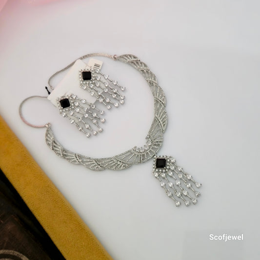 silver tone AD necklace set with black square stones, black stone American Diamond necklace with matching earrings, designer silver necklace set for women, criss-cross pattern AD necklace, black square stone dangling earrings, elegant party wear imitation jewellery set, silver finish necklace for weddings and receptions, Scofjewel AD necklace set