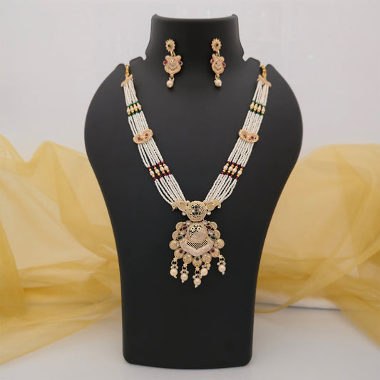 traditional white beaded long necklace set with antique gold tone pendant and matching earrings, multicolour stone ethnic necklace for women, artificial jewellery set with pearl drop detailing, traditional Indian necklace for weddings and festivals