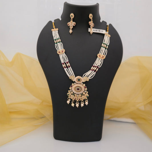 traditional white multistrand beaded necklace set with antique gold tone circular pendant and matching earrings, artificial jewellery with green and maroon stone accents, ethnic necklace set for women, traditional Indian wedding and festive jewellery