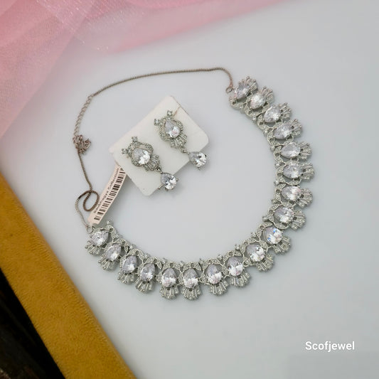 white AD stone necklace set with matching earrings, white teardrop crystal-style necklace for women, silver-tone designer necklace set, elegant artificial jewellery with sparkling white stones, party wear necklace and earrings set, wedding jewellery set for women, teardrop white stone necklace with matching drop earrings, Scofjewel white necklace set